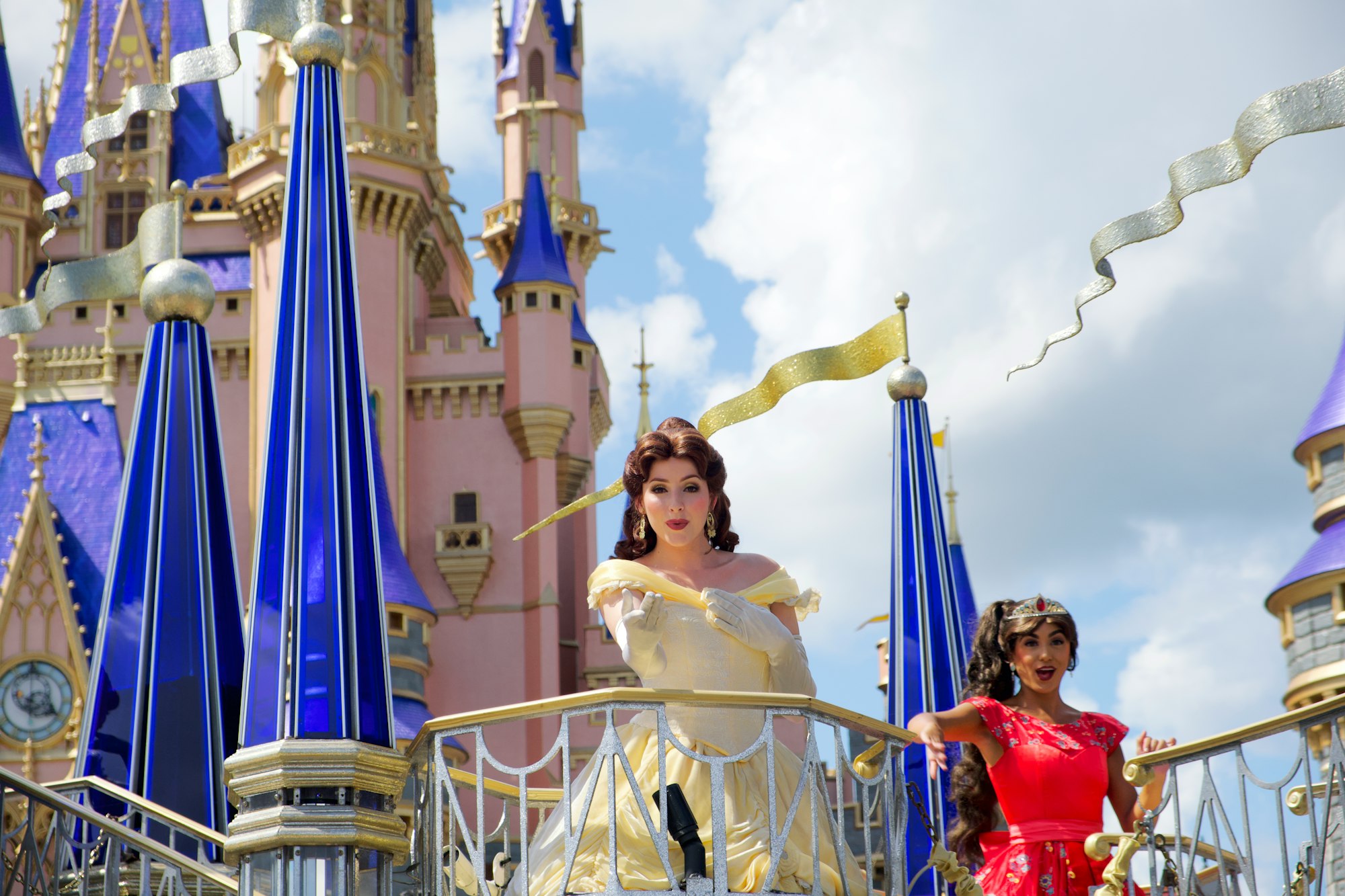 Princess blowing a kiss from a parade float in front of Cinderella Castle at Walt Disney World ✨