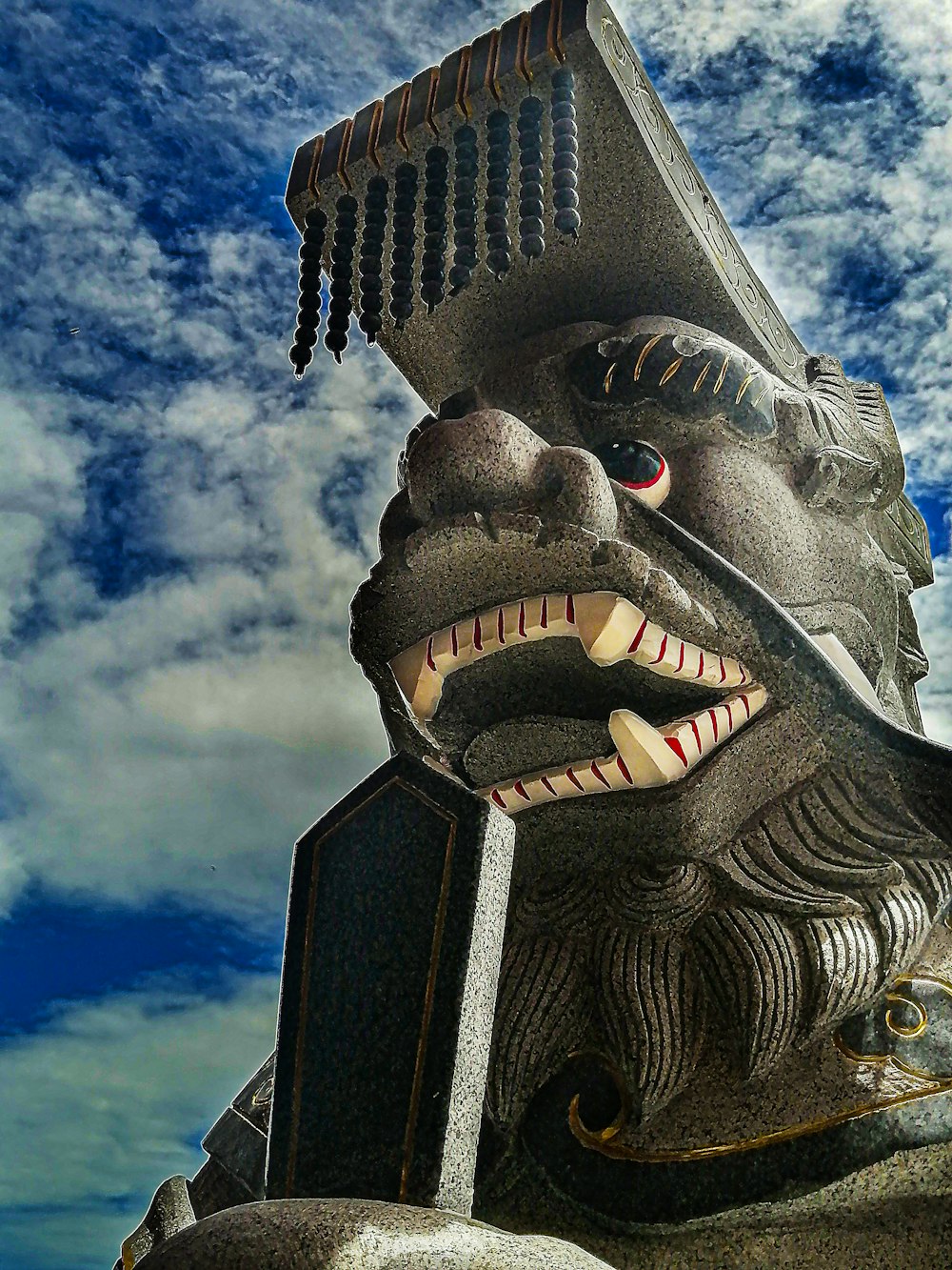 grey concrete dragon statue under blue sky during daytime