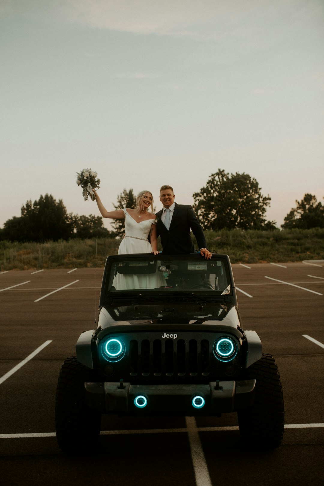 man and woman riding on green and black jeep wrangler