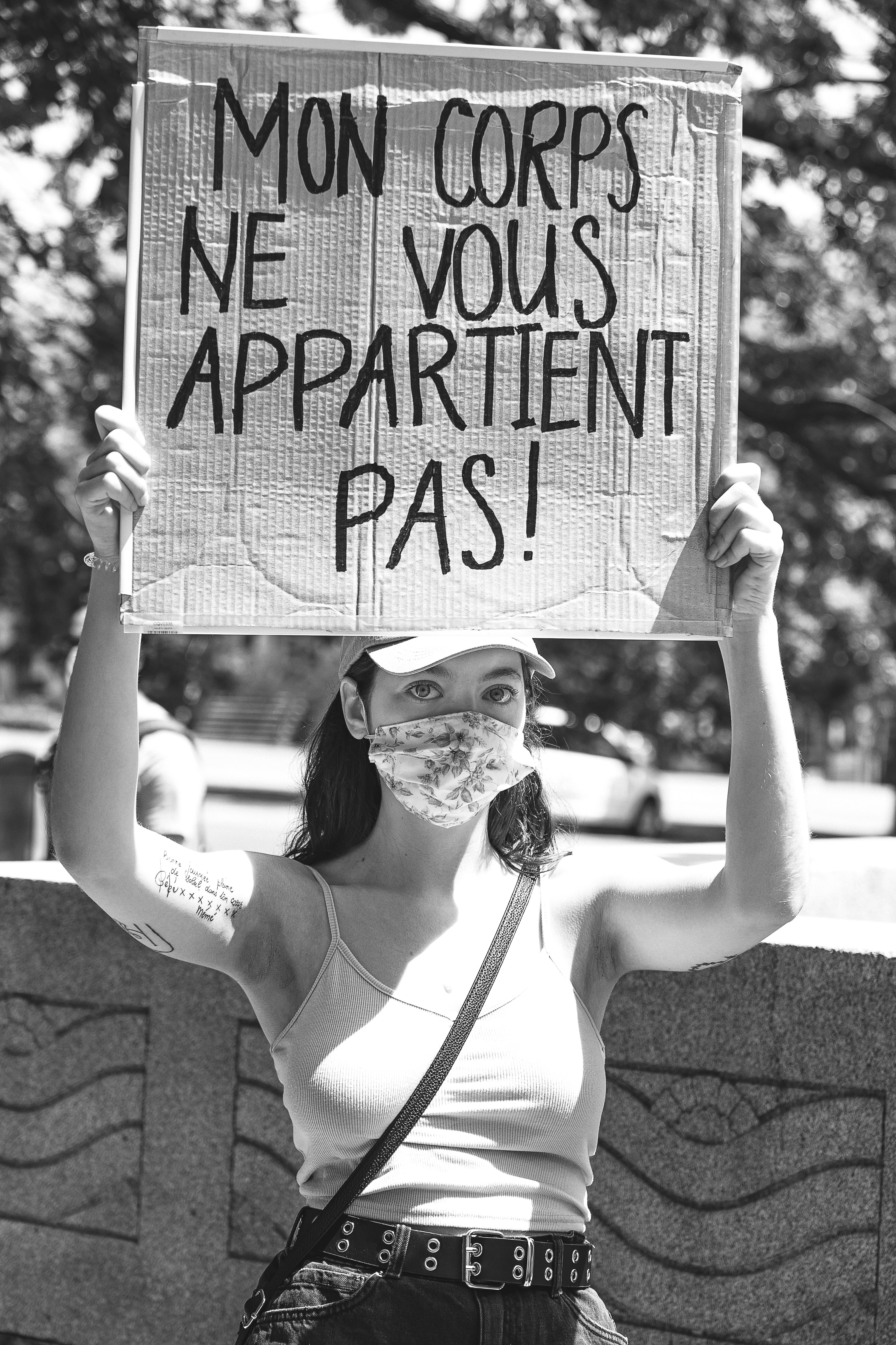 woman in white tank top holding happy birthday signage