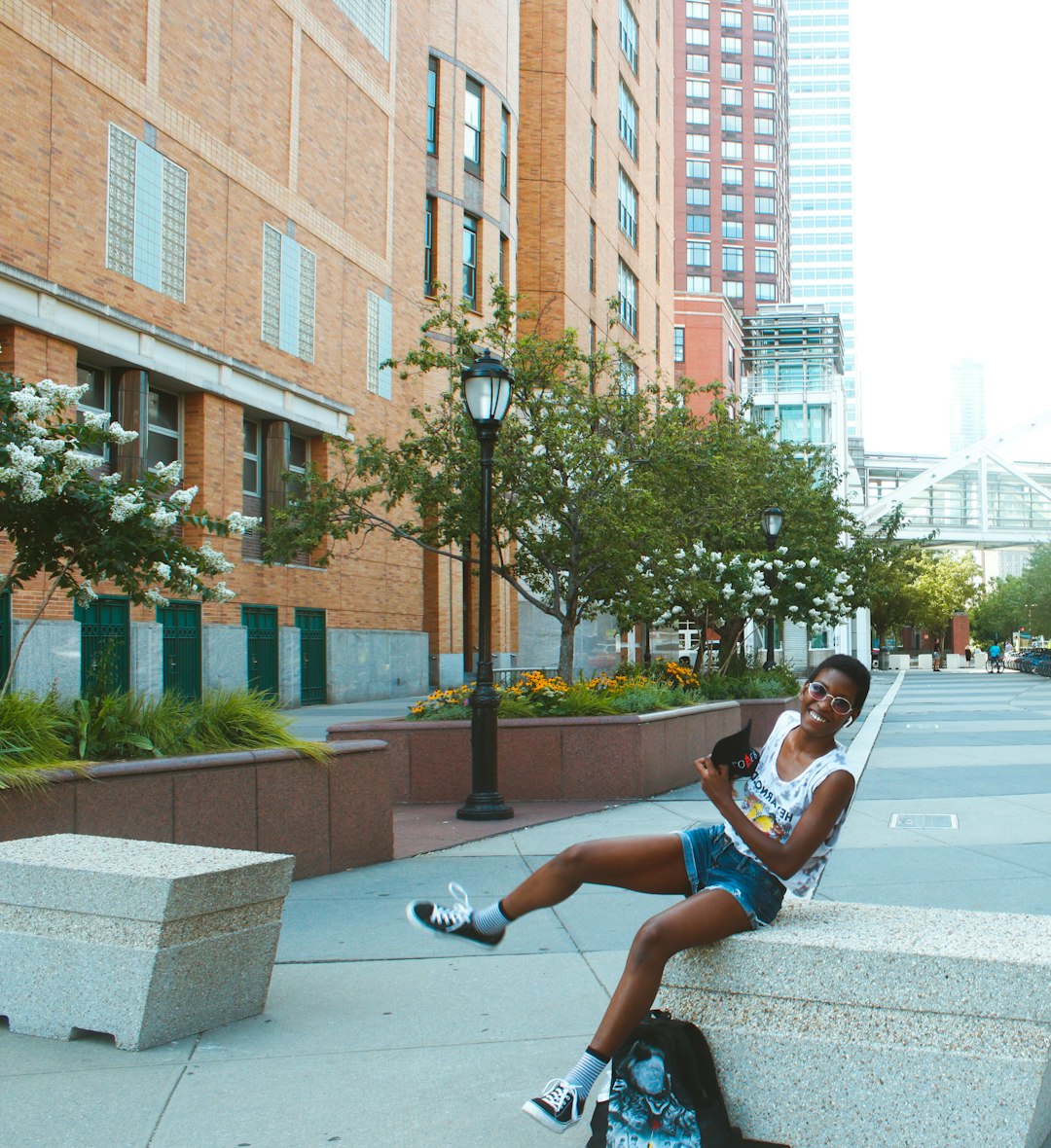 man in blue t-shirt and blue shorts sitting on gray concrete bench during daytime