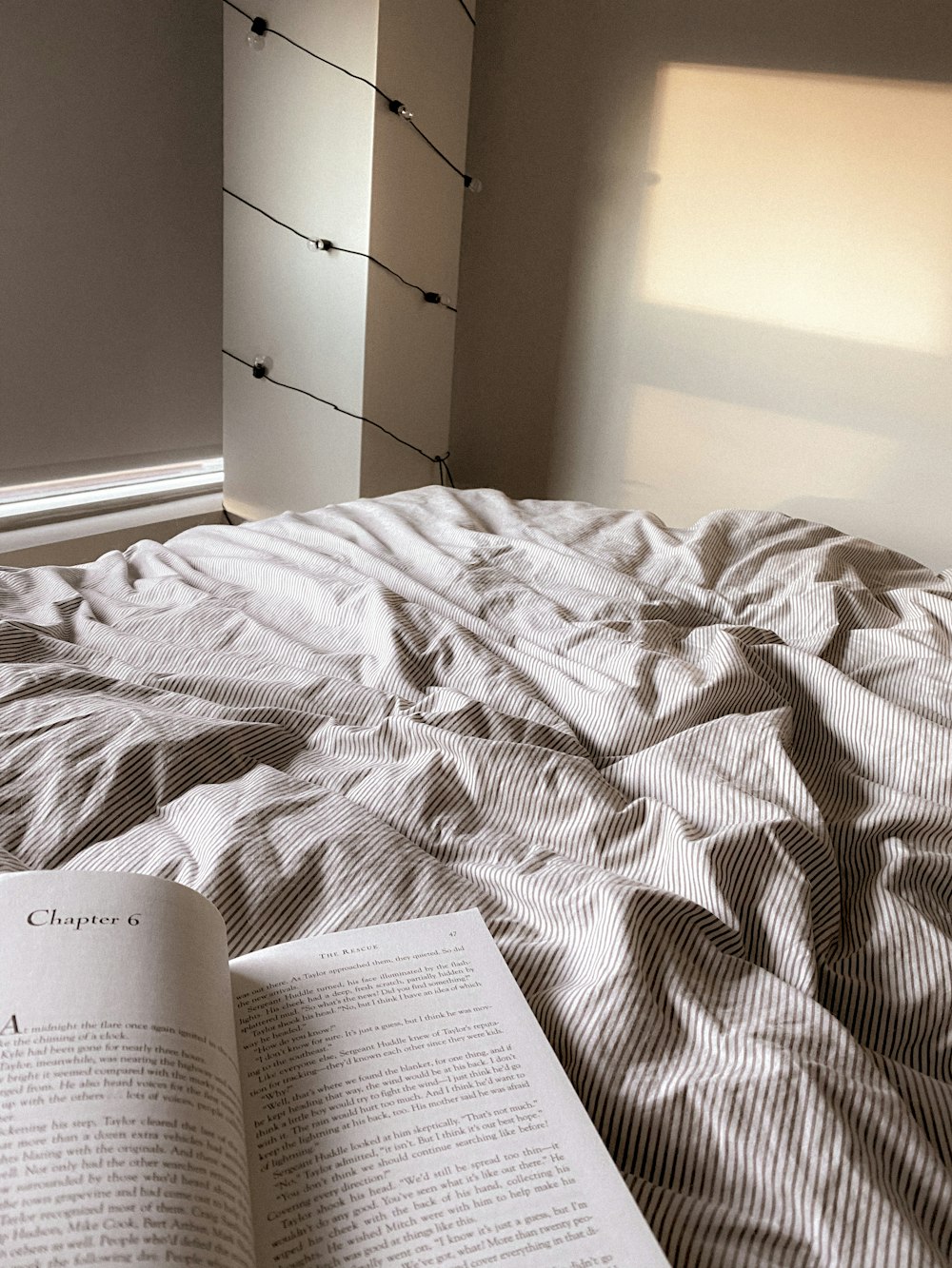 an open book is laying on a bed