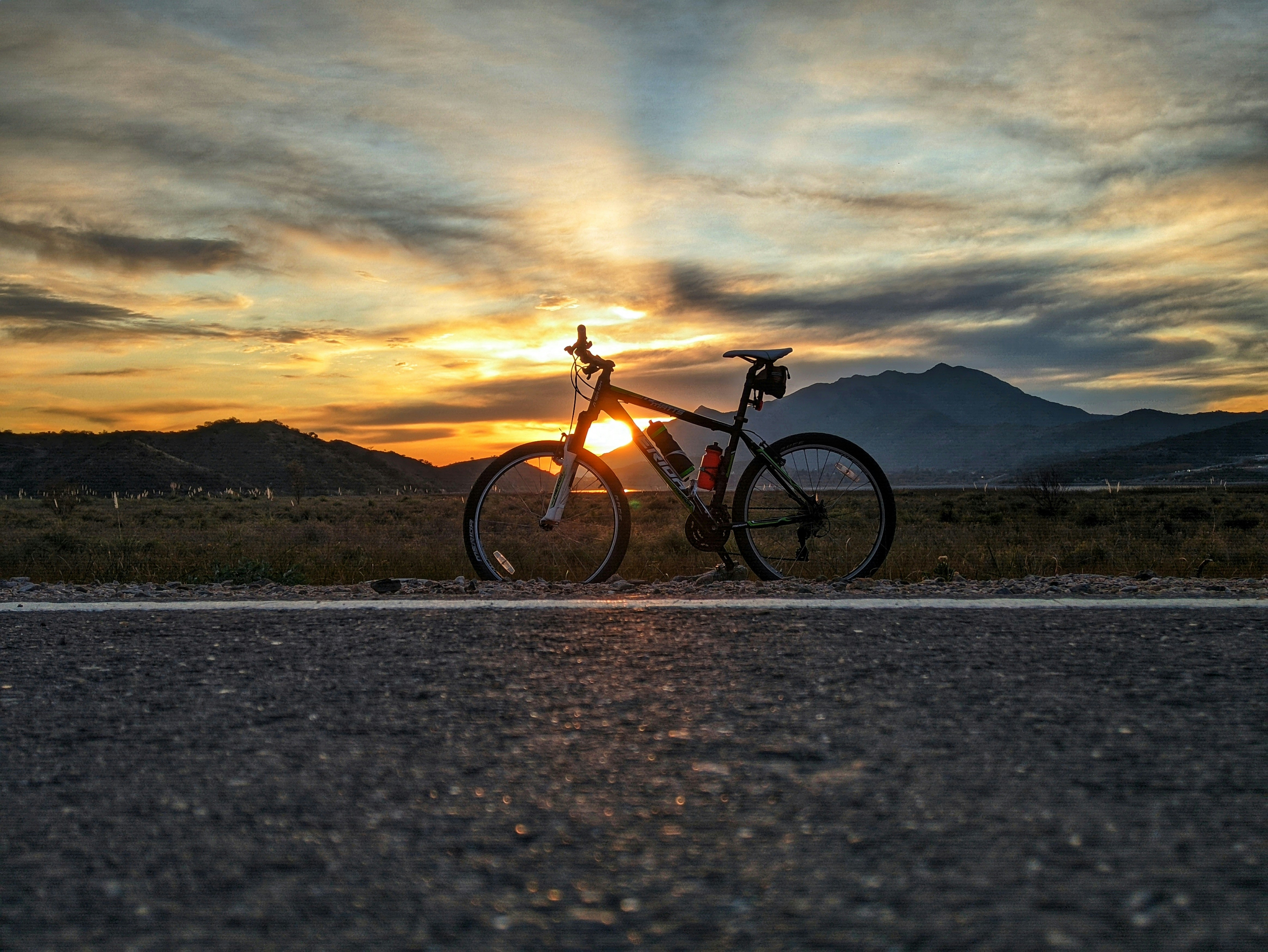 black and brown mountain bike on gray sand during daytime
