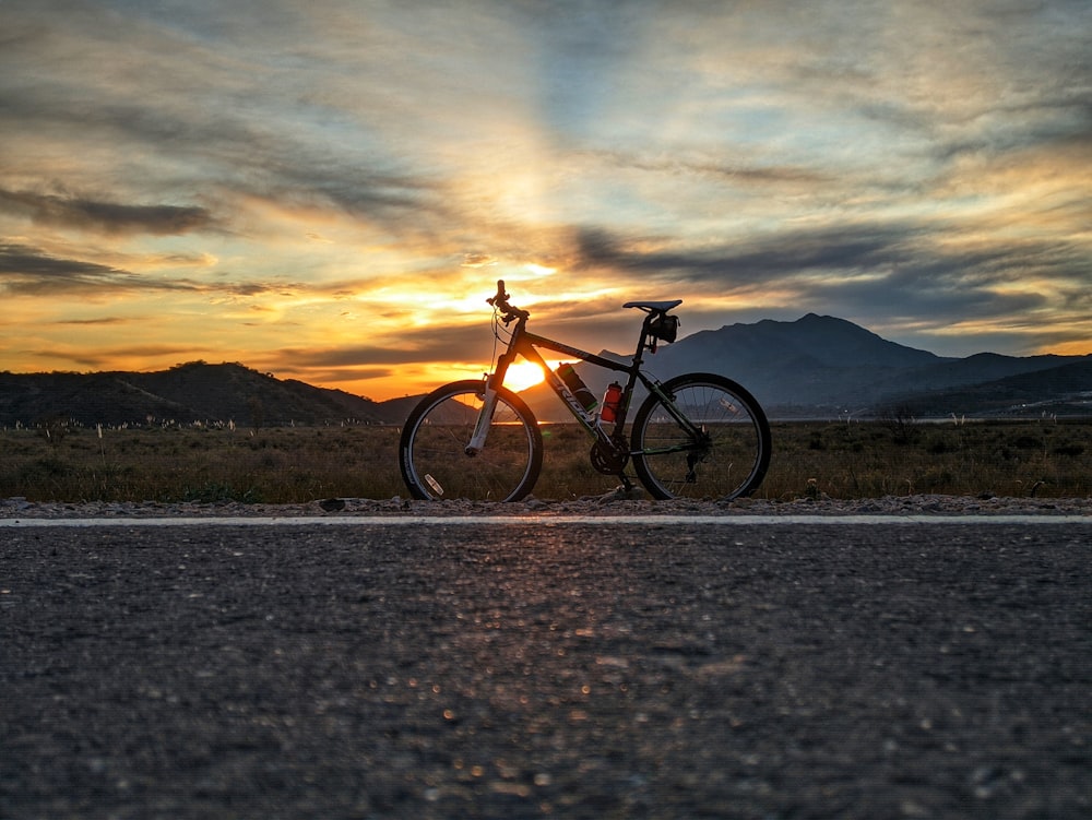 black and brown mountain bike on gray sand during daytime