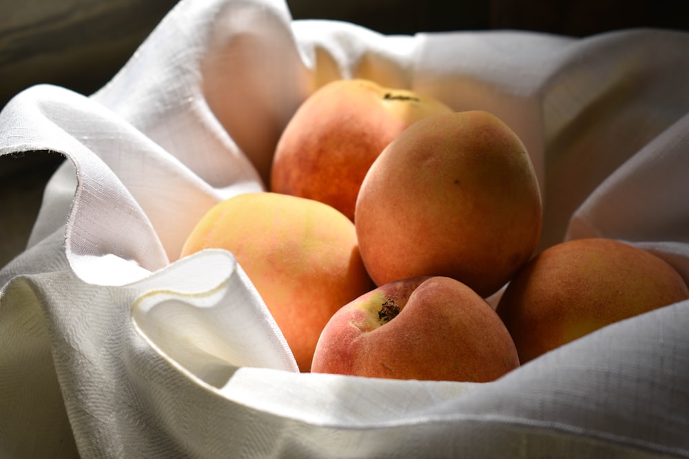 brown round fruits on white textile