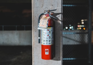 red fire extinguisher mounted on wall