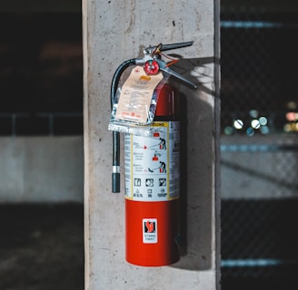 red fire extinguisher mounted on wall