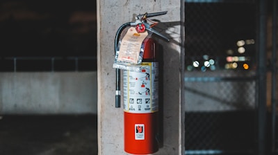 red fire extinguisher mounted on wall