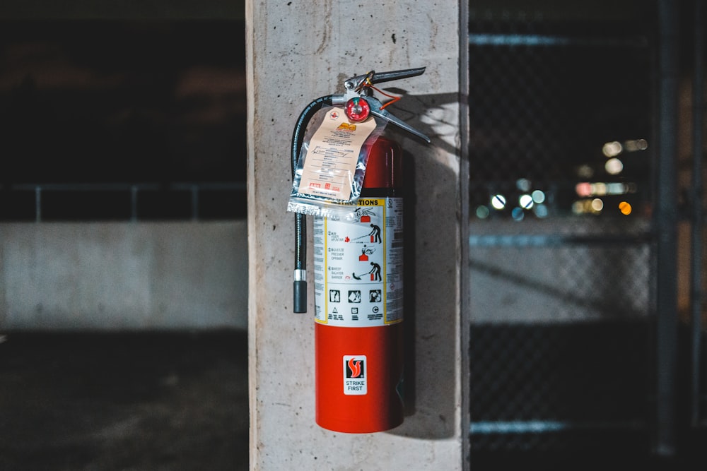 red fire extinguisher mounted on wall