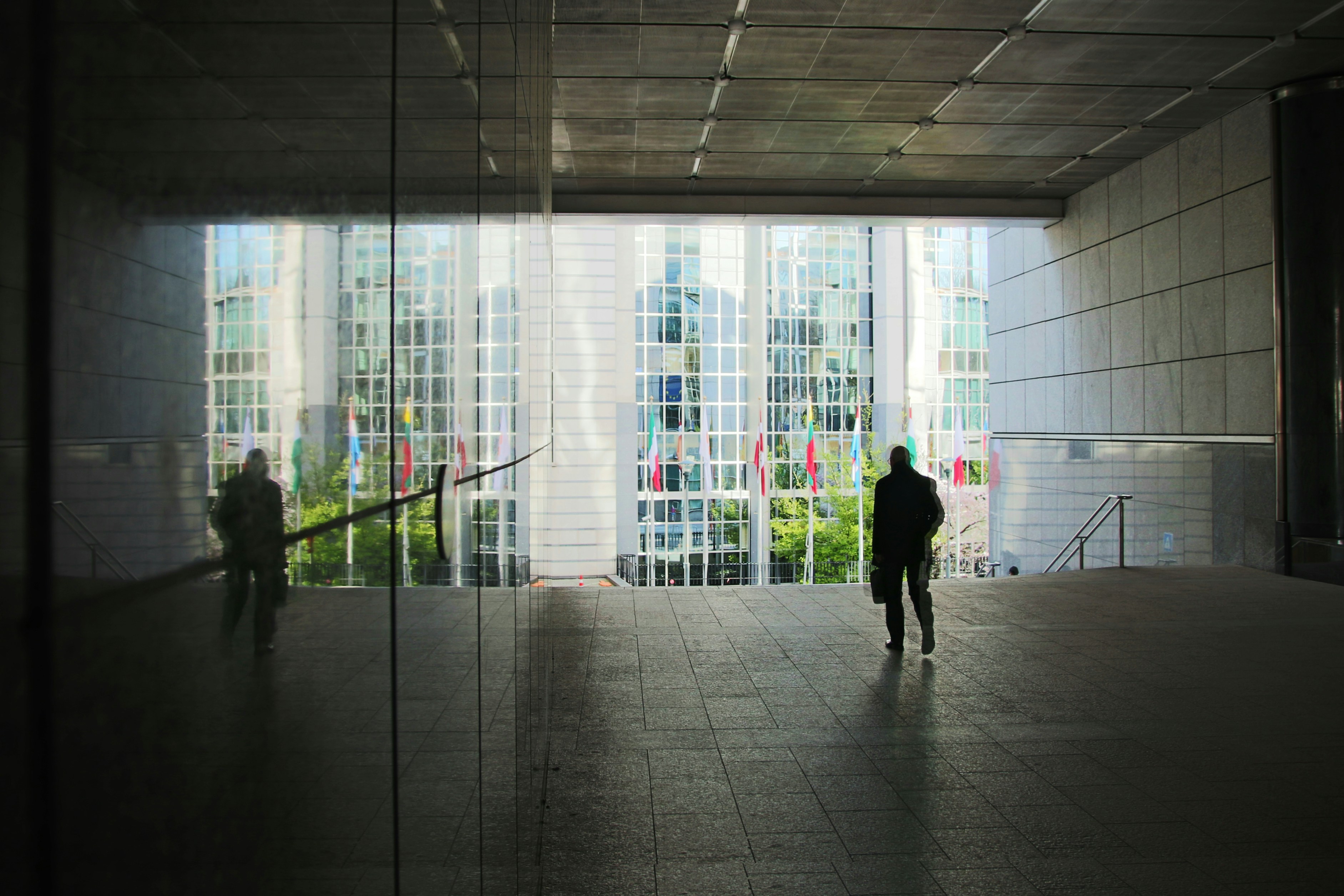 silhouette of 2 person walking on hallway