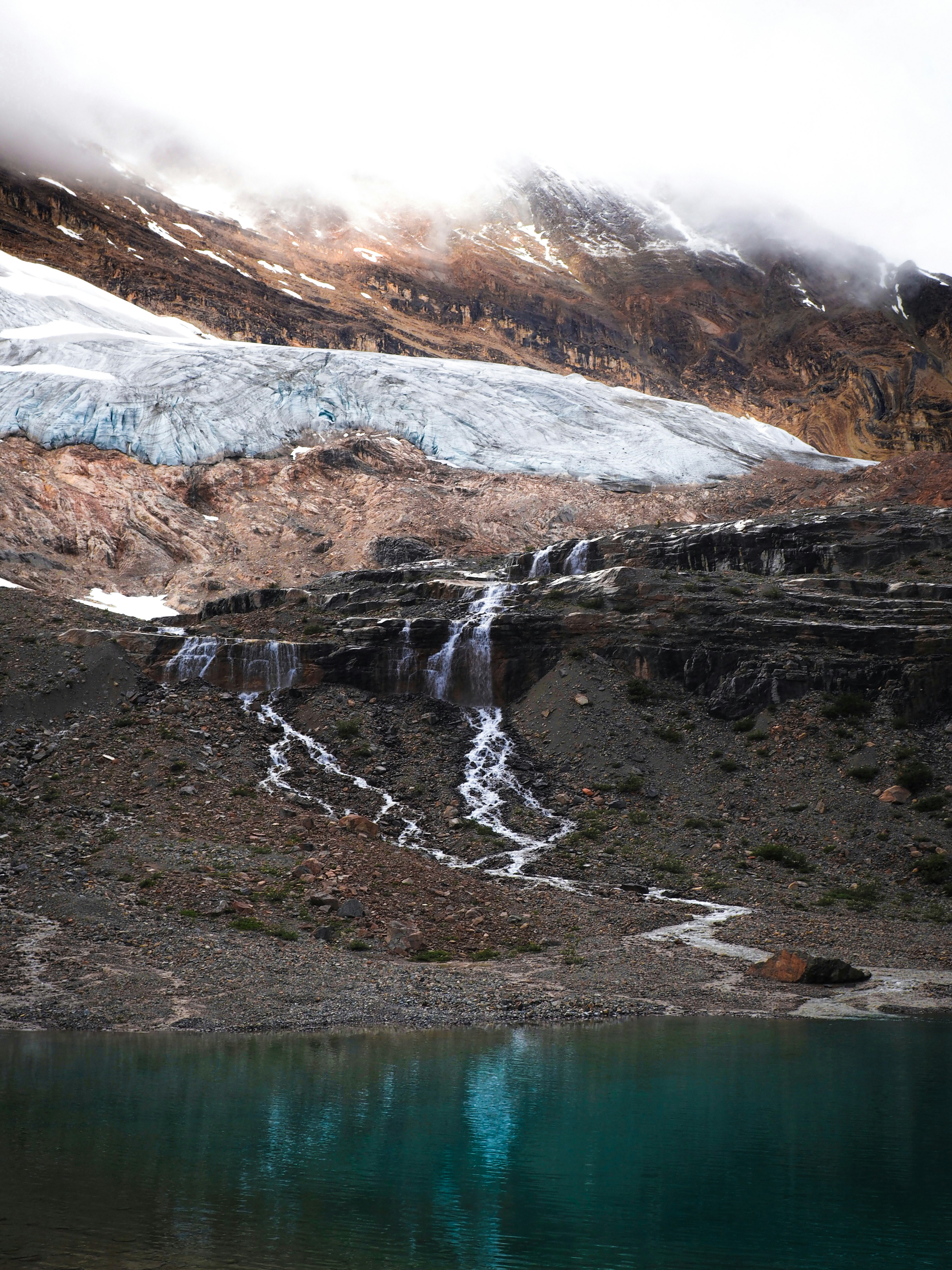 A glacial stream pouring into a small tarn in Yoho, Alberta, Canada. Cut through by the Iceline Trail, this area was entirely covered by a glacier not 100 years ago – a personal look into the new landscapes carved by climate change. 
