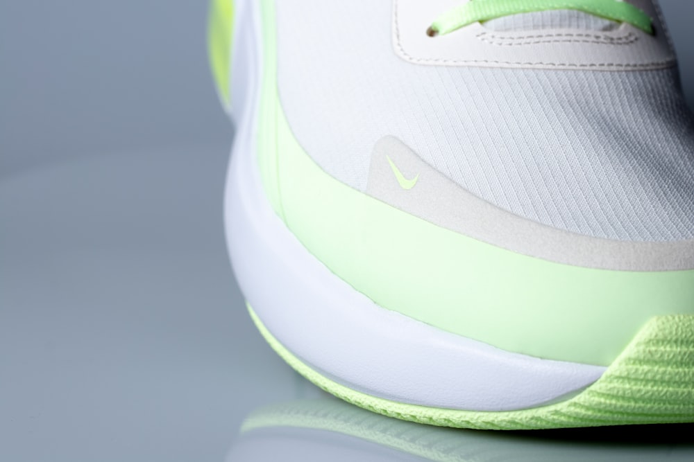 white and green nike athletic shoe
