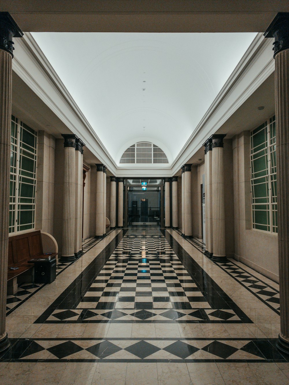 empty hallway with brown wooden chairs and tables