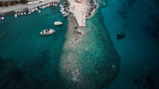 white boat on body of water during daytime in Kardamyli Greece