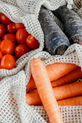 A vibrant assortment of freshly picked vegetables displayed on a dark green cloth.