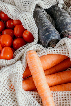A vibrant assortment of freshly picked vegetables displayed on a dark green cloth.