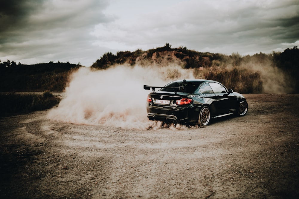 black chevrolet camaro on brown field during daytime