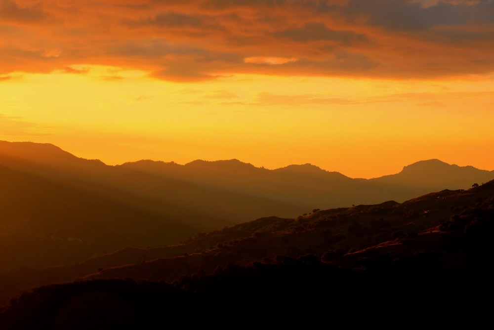 silhouette of mountains during sunset