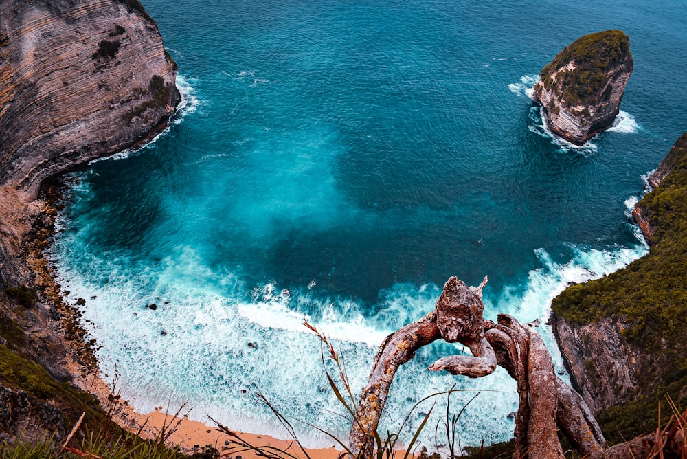 brown rock formation on blue sea during daytime