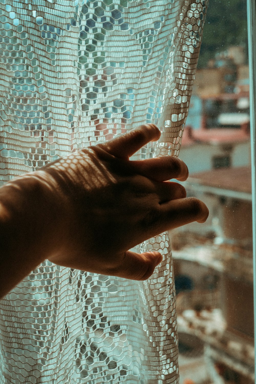 persons left hand on white mesh net