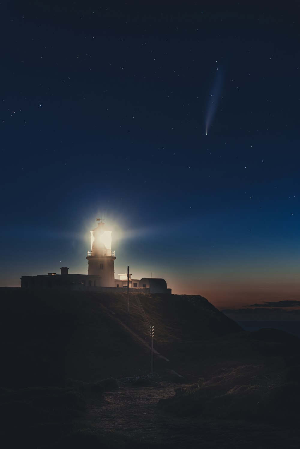 silhouette of lighthouse during night time