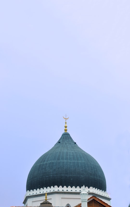 green dome building under white sky during daytime in Penang Island Malaysia