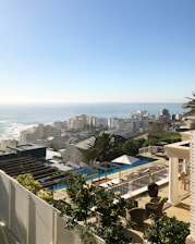 Architect reviewing detailed blueprints in a bright office overlooking Cabo Frio coastline