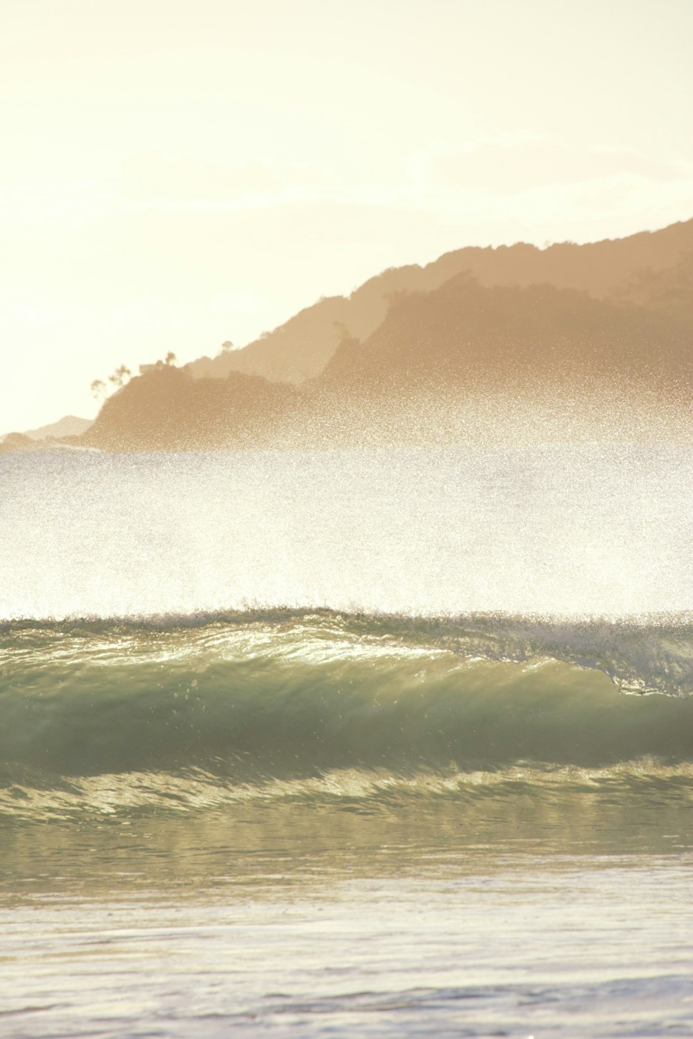 ocean waves crashing on shore during daytime