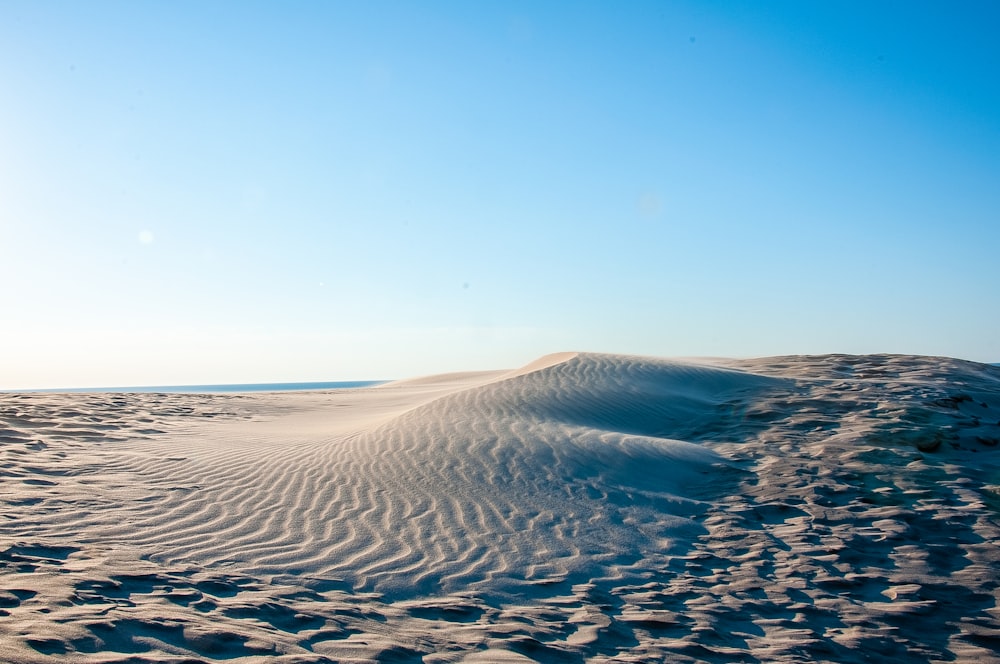 brown sand under blue sky during daytime