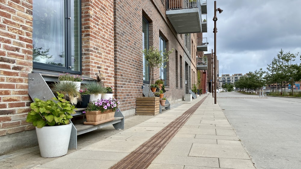 brown brick building with green plants and trees