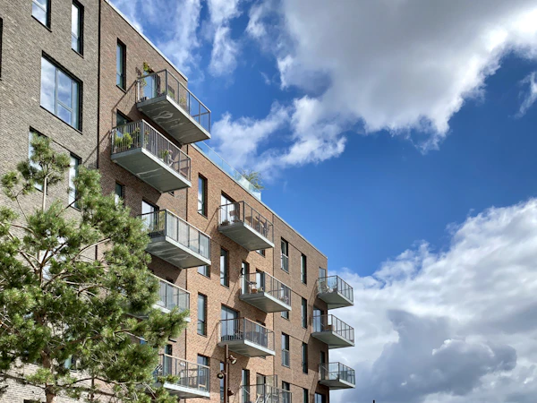 Brick apartment building under blue sky