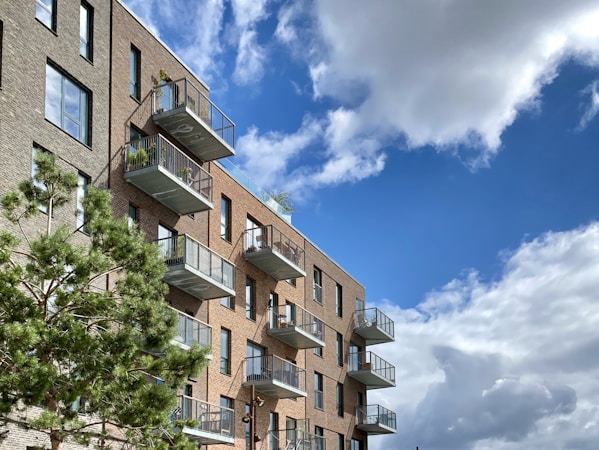 Exterior of a residential apartment block under clear skies, similar to rental buildings in Winchester and North Las Vegas where one-bedroom rents fell the most
