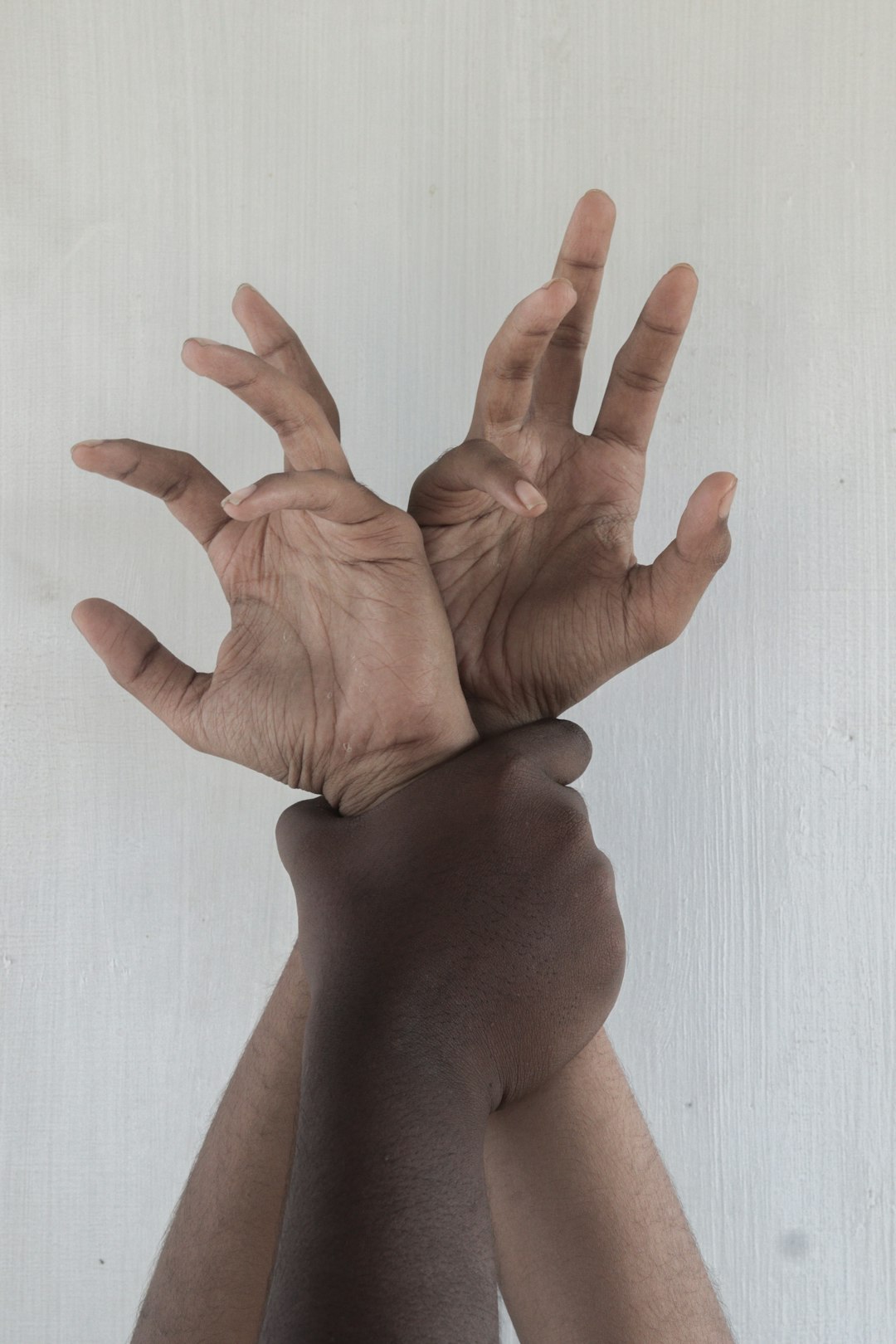 persons hand on white surface