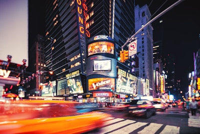 A lively night scene of Times Square glowing with neon lights in New York.