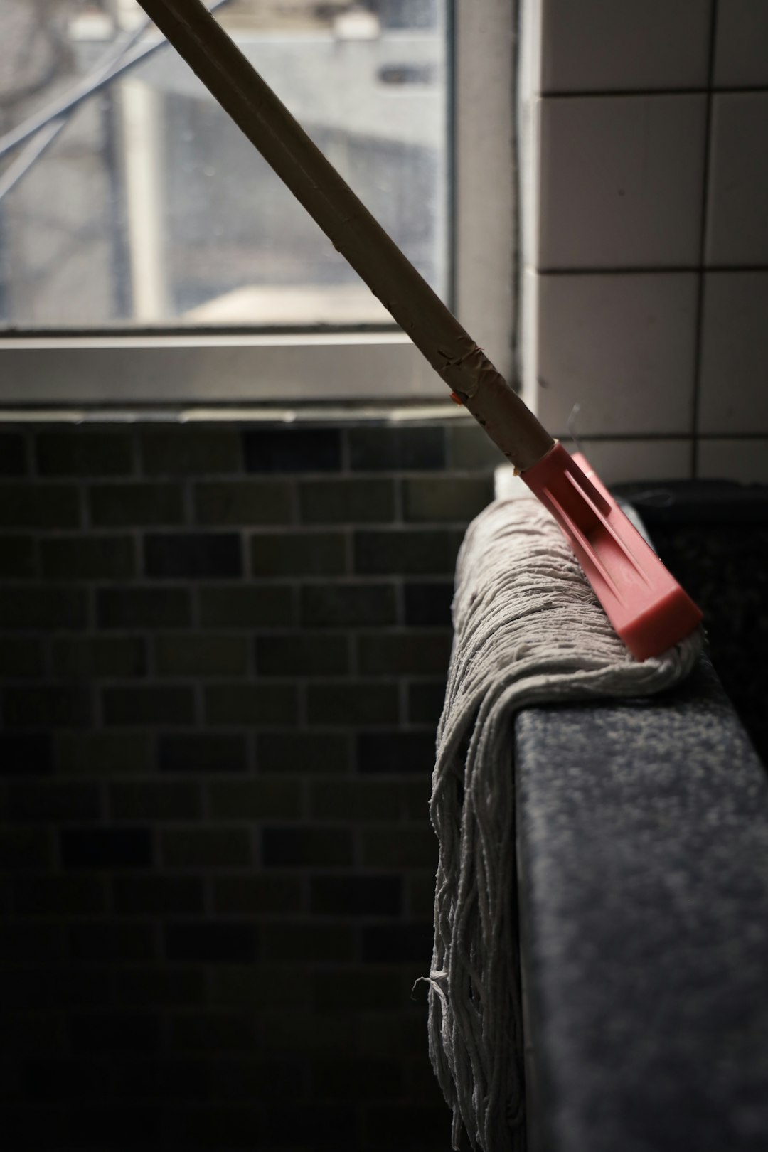 red and white mop on gray textile