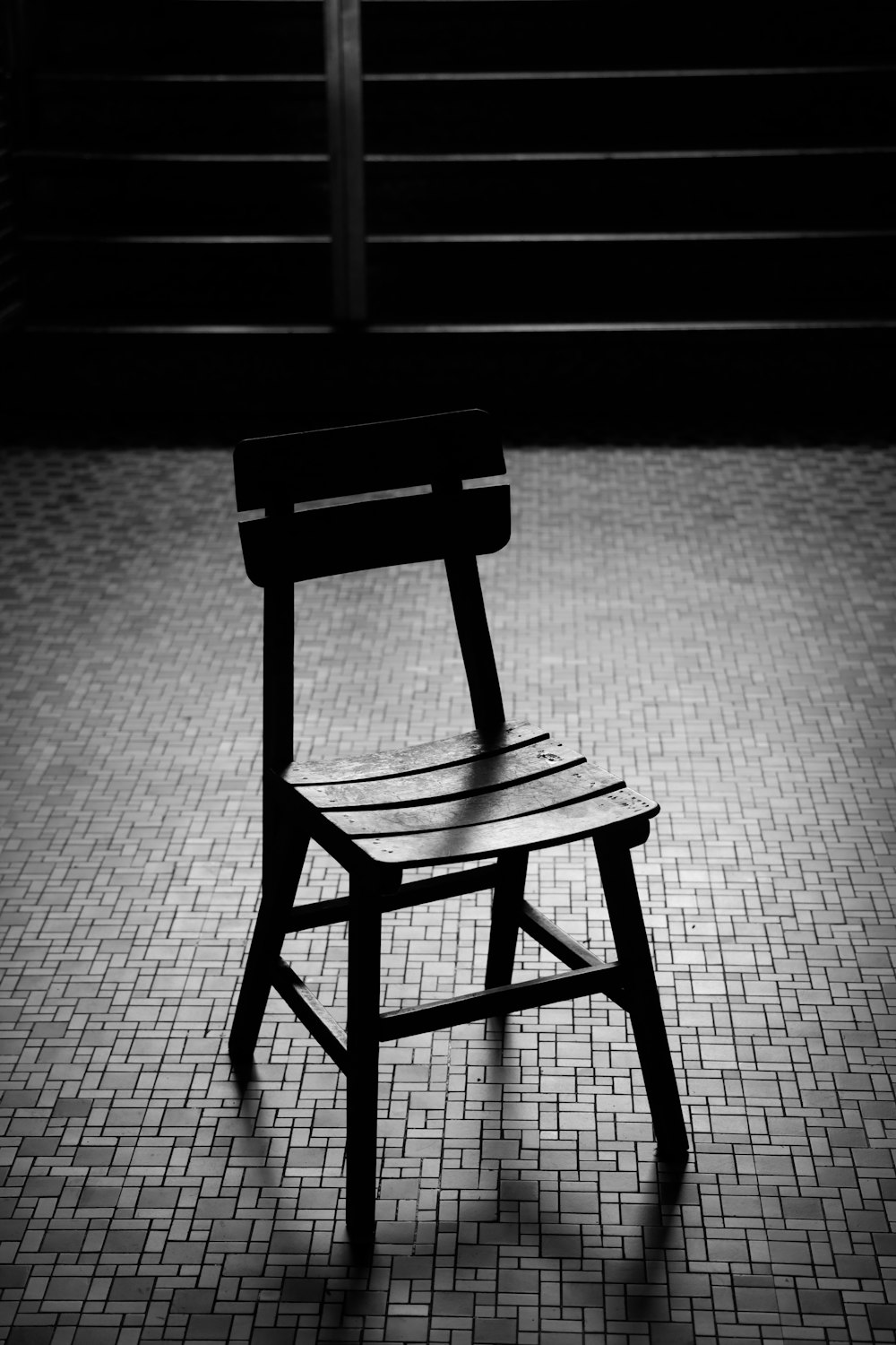 black wooden chair on gray textile