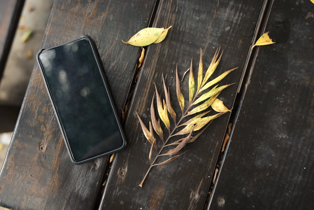 black iphone 7 on blue wooden table