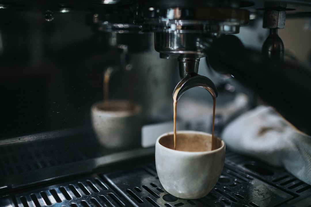 white ceramic cup on silver espresso machine