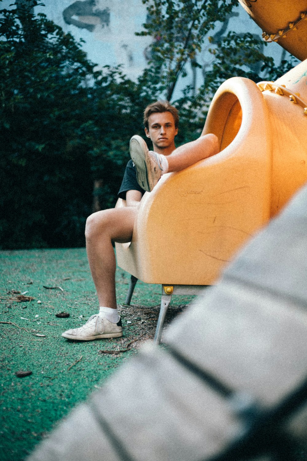 woman in white t-shirt sitting on orange chair