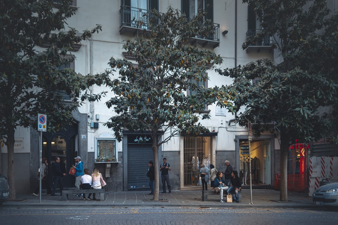 people walking on sidewalk near building during daytime