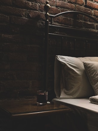 Close-up of elegant bedroom accessories like silk blindfolds and satin restraints on a soft bed.