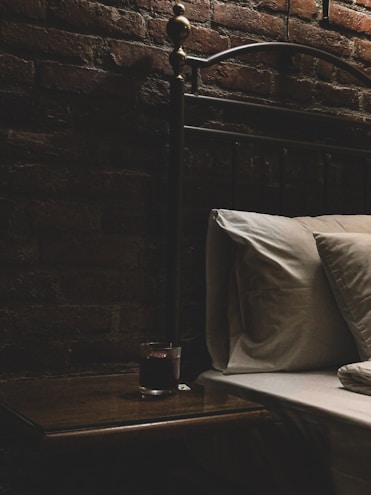 Close-up of elegant bedroom accessories like silk blindfolds and satin restraints on a soft bed.