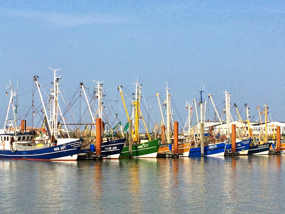 green and blue boat on water during daytime