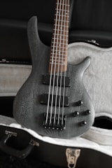 Modern bass guitar with vibrant blue finish and sleek curves.