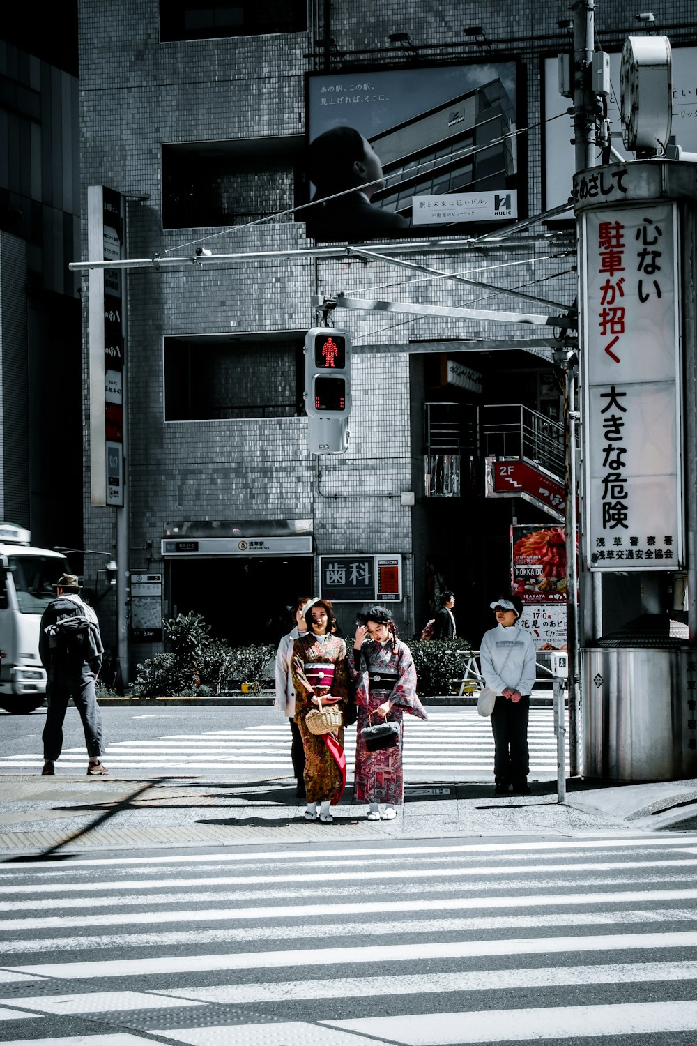 man in red and white jacket walking on pedestrian lane during daytime