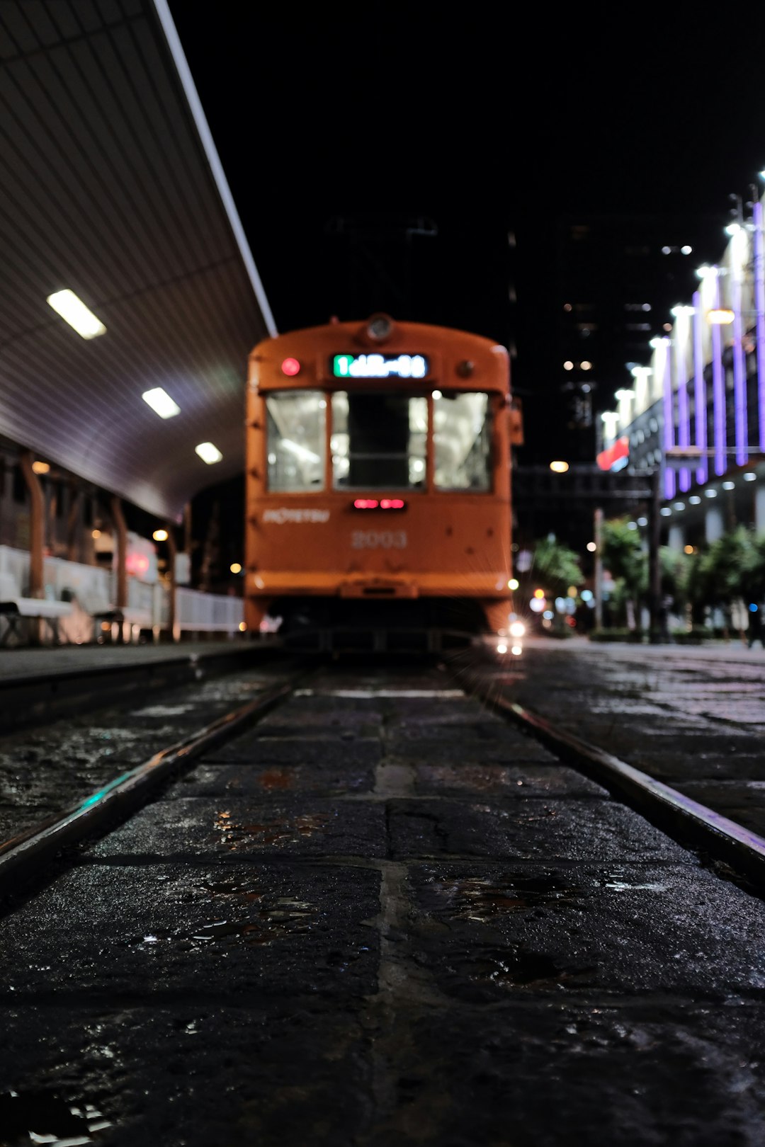 yellow and white tram on the street during night time