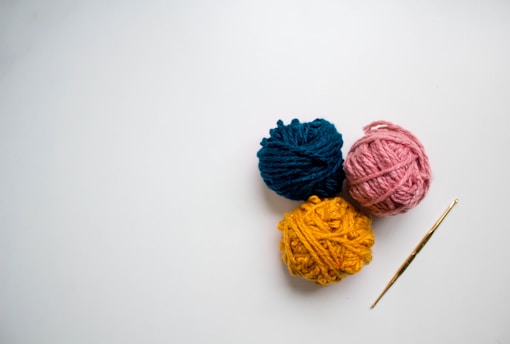 blue and red yarn on white surface