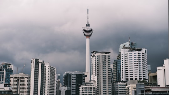 white and gray concrete building under gray sky in Menara Kuala Lumpur Malaysia