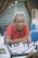 man in orange polo shirt sitting by the table