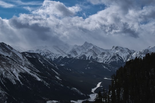 snow covered mountains under cloudy sky during daytime in Highwood Pass Canada